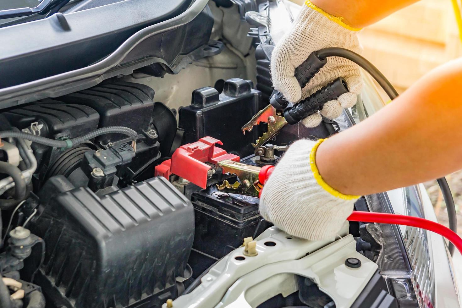 Charging car battery with electricity trough jumper cables photo