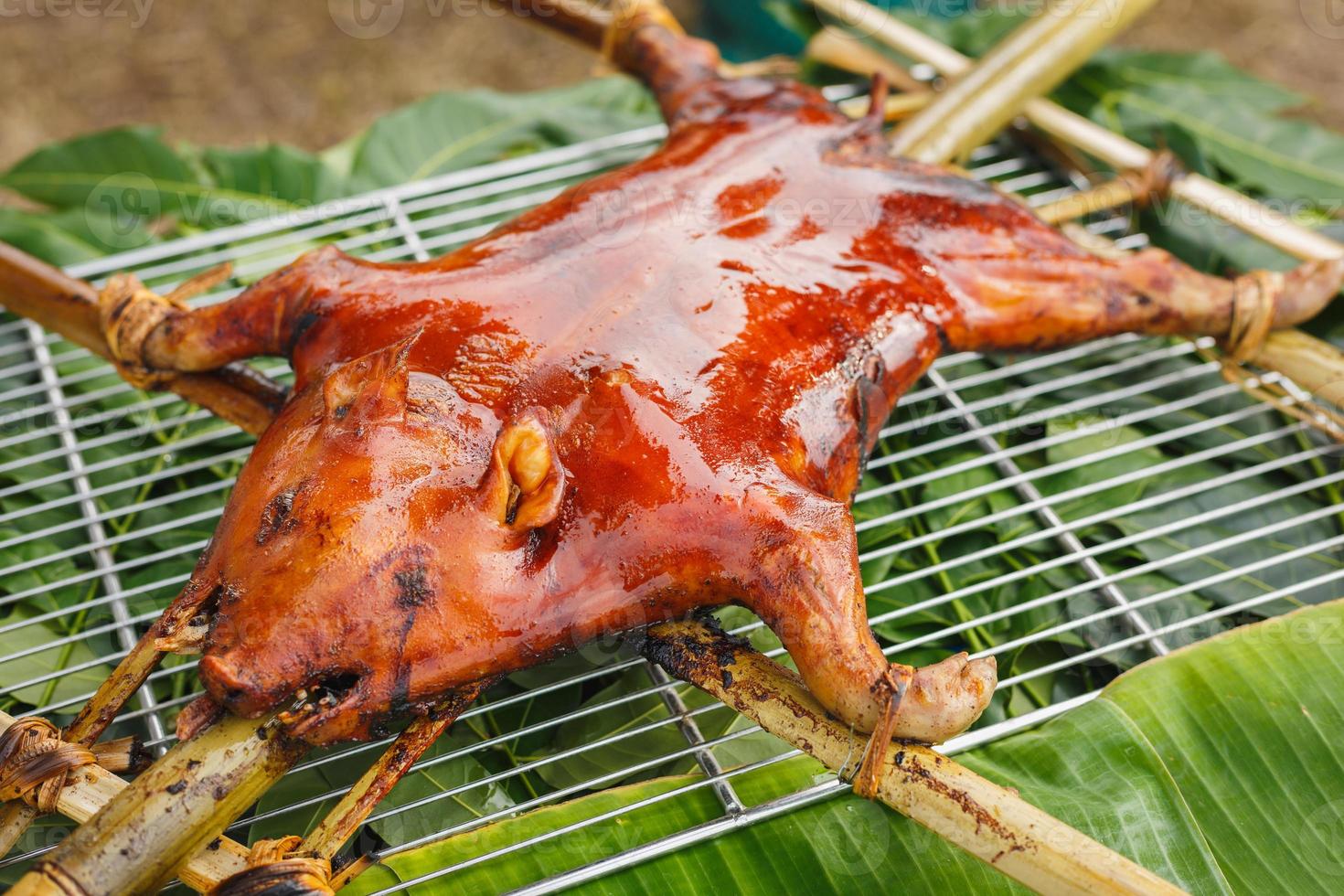 Suckling pigs on banana leaves photo