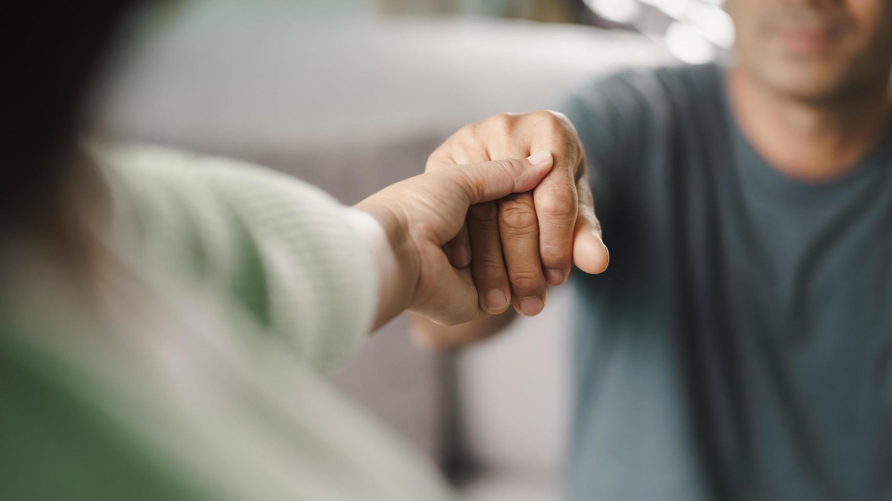 friend or family sitting and hold hands cheer up to mental depress man photo