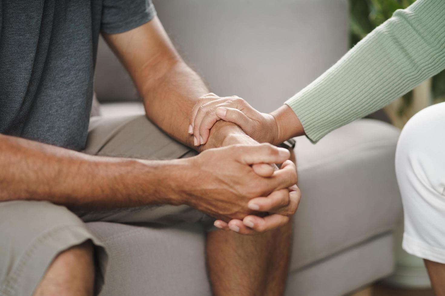 friend or family sitting and hold hands cheer up to mental depress man photo