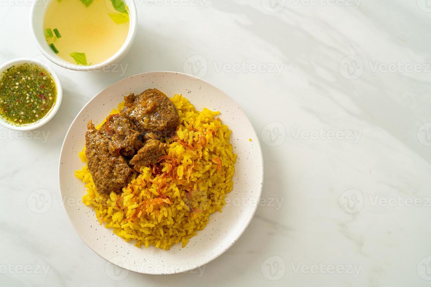 Beef biryani or curried rice and beef photo