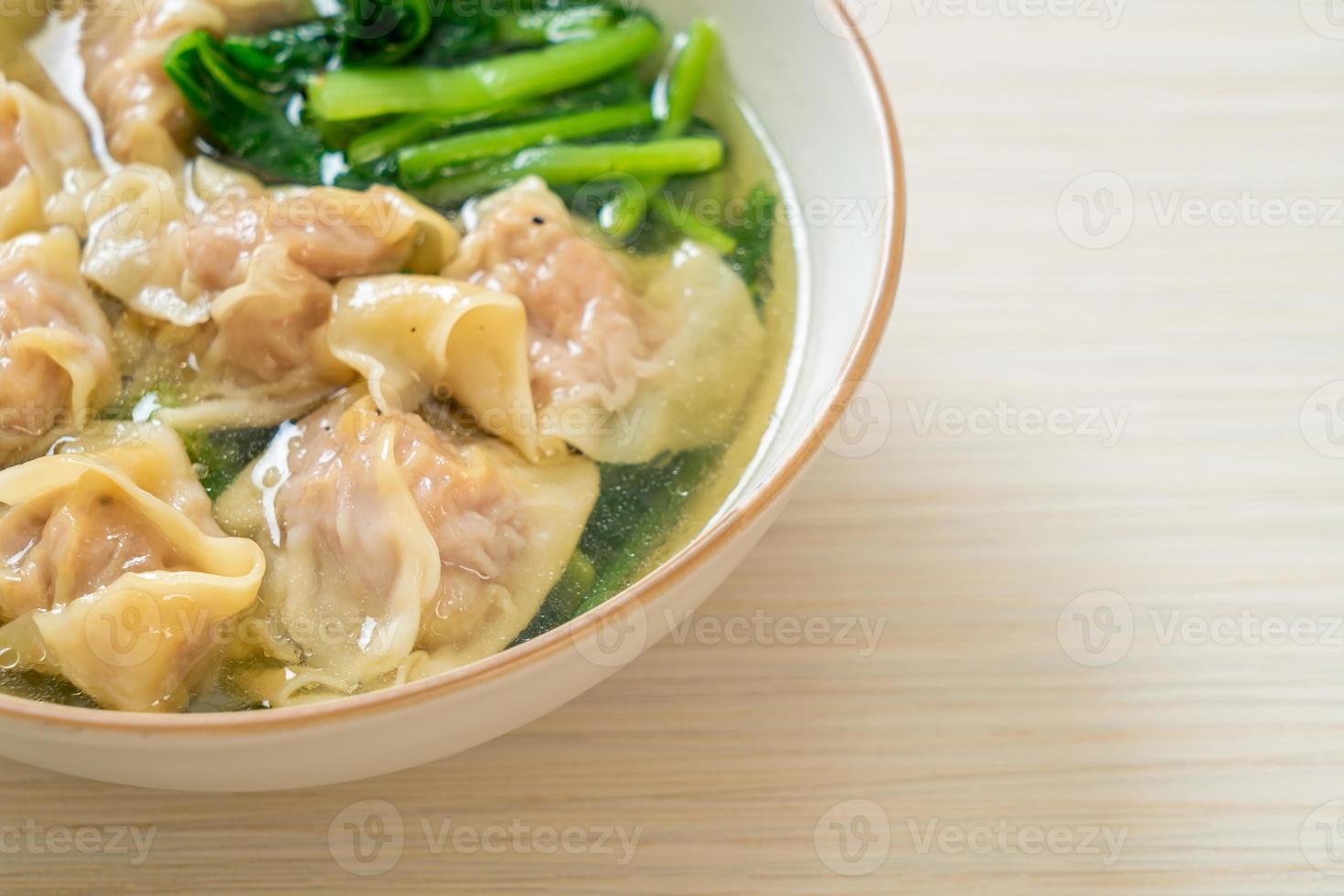 Pork wonton soup or pork dumplings soup with vegetable photo