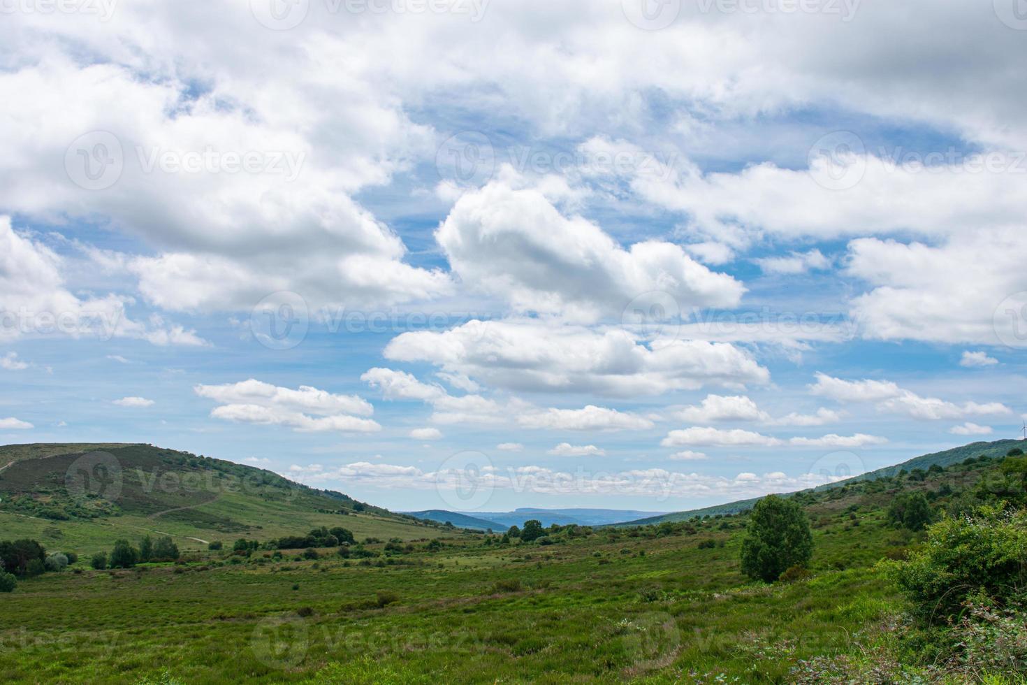 High mountain meadow with a sky full of clouds photo