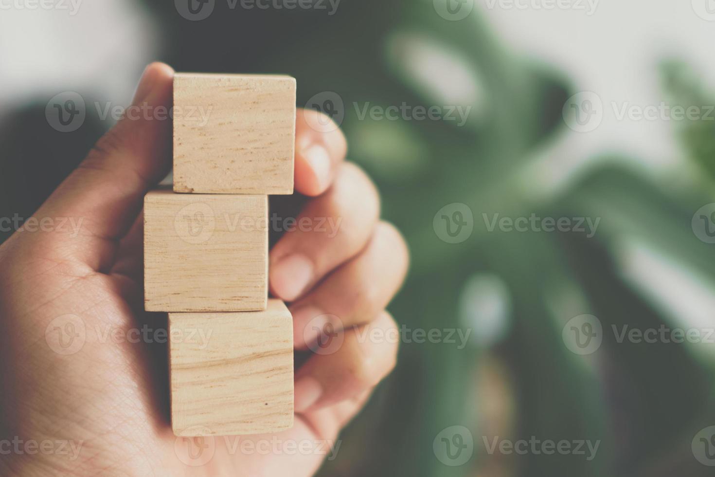Blank wooden cube that you can put text or icon on in hand hold photo