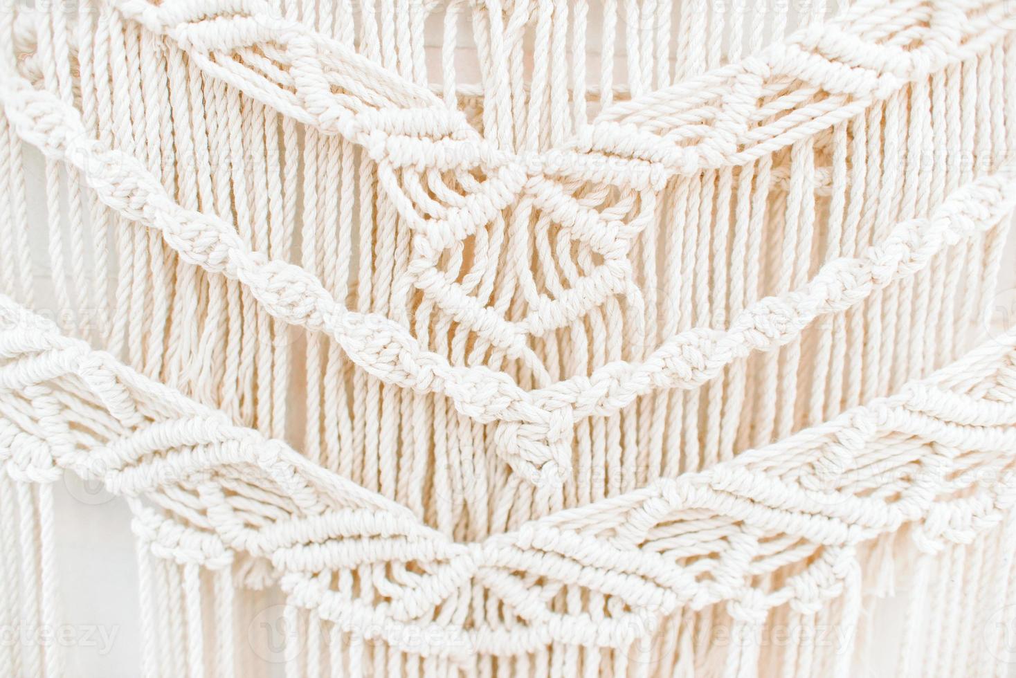 Handmade macrame pattern a fragment of a wall panel in the boho style photo