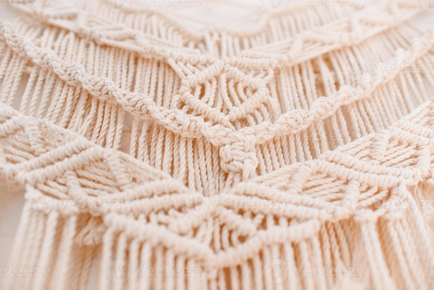 Handmade macrame pattern a fragment of a wall panel in the boho style photo
