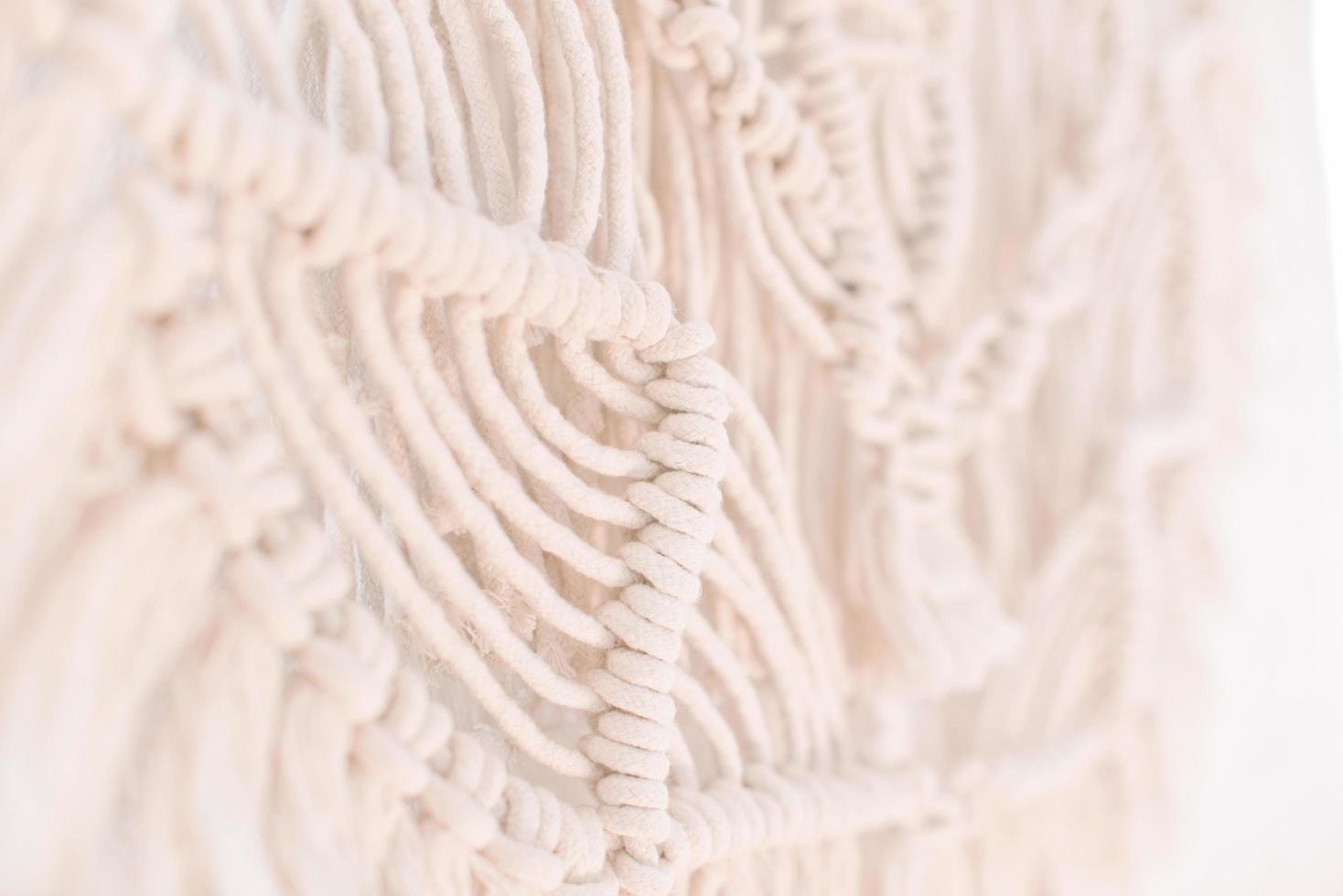 Wall panel in boho style made of cotton threads of natural color photo