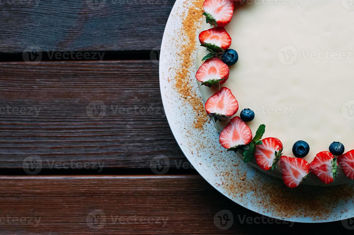 Top view cake with berries and white glaze photo