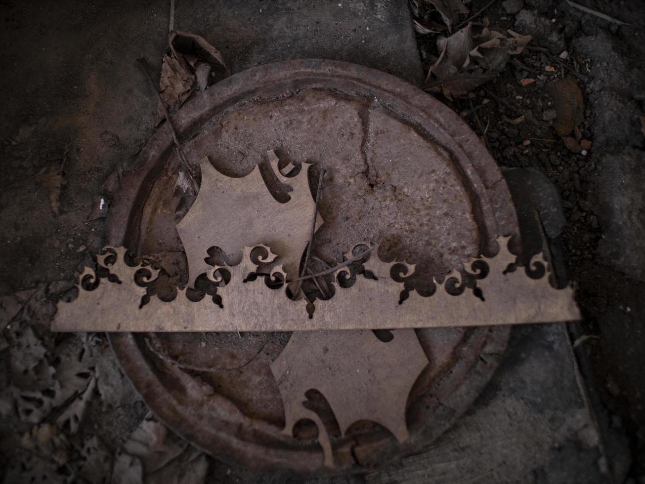 abstract wooden pattern on rusty iron cover on the ground photo