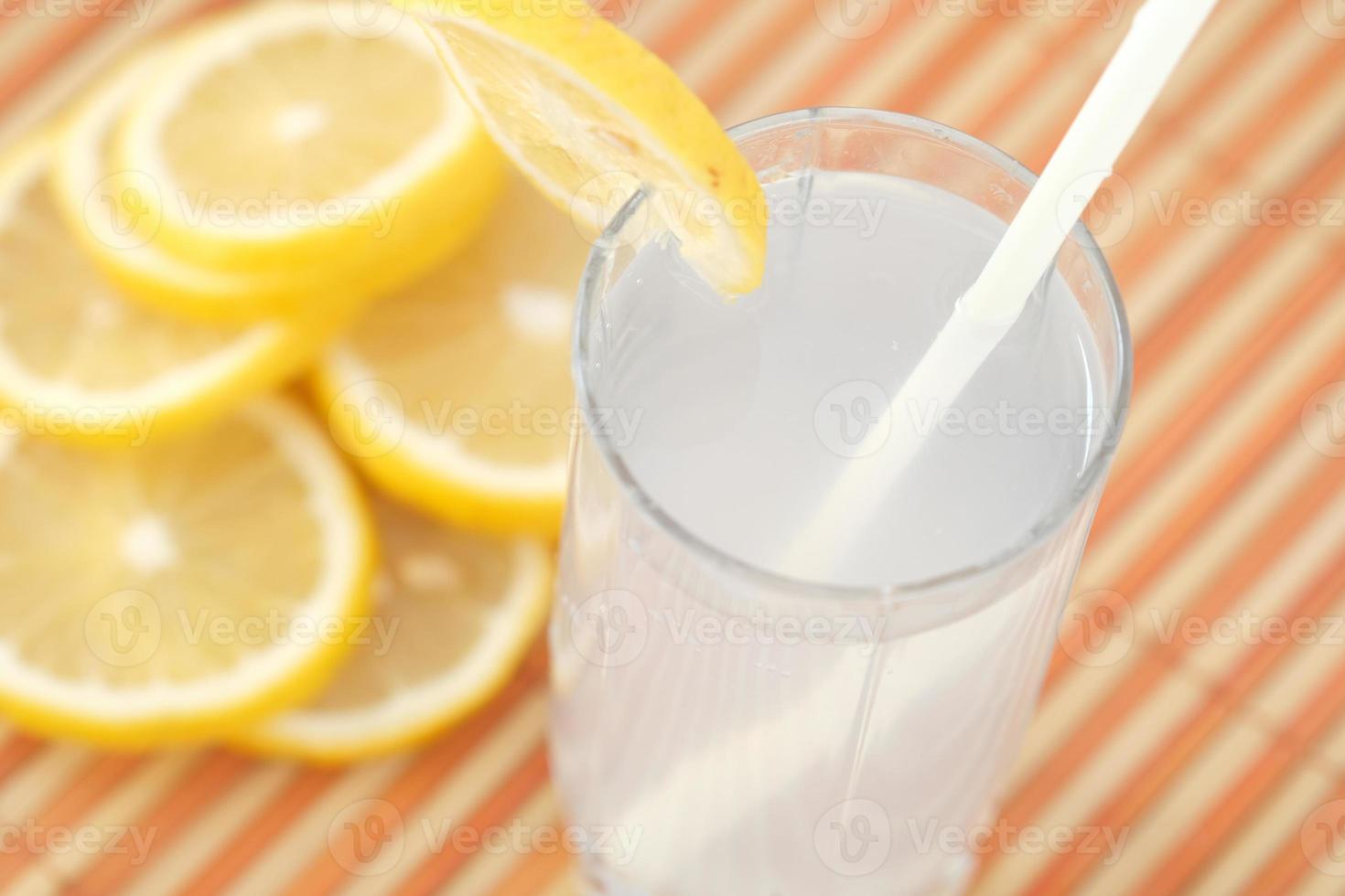 refrescante bebida de agua con limón en la mesa, vista superior foto