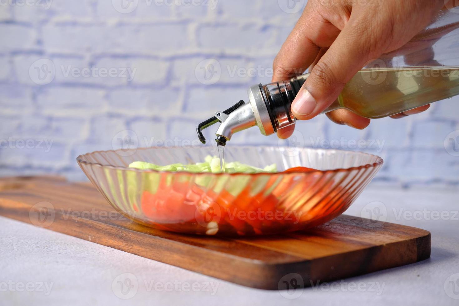 Pouring vegetable oil into a bowl close up photo