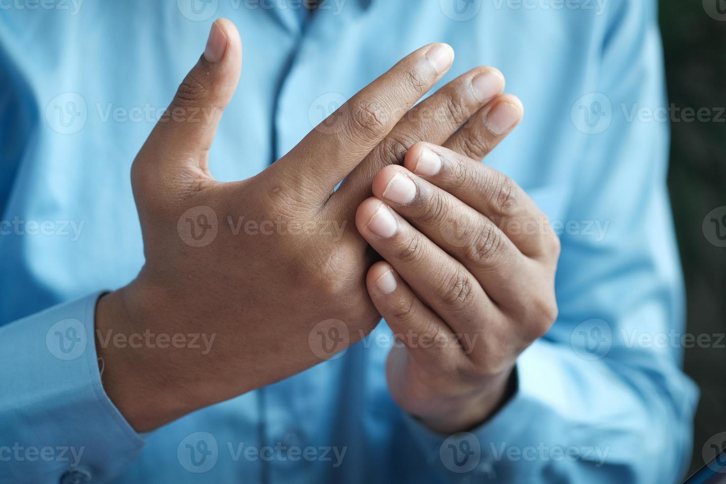 man suffering pain in hand close up photo