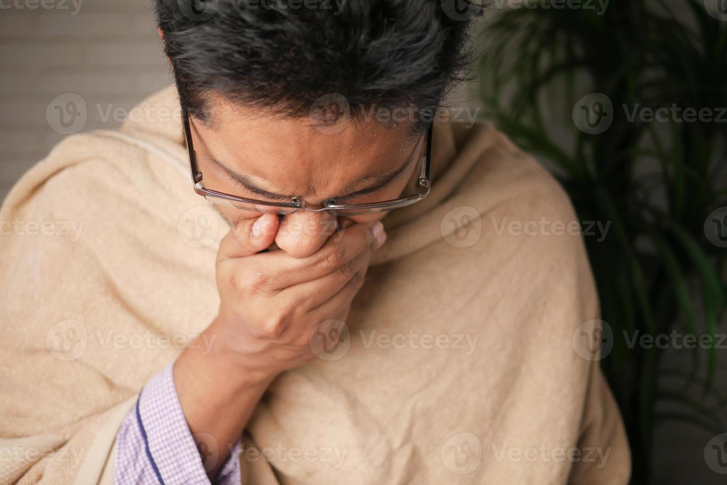 Mature man felling sick and coughs at home photo