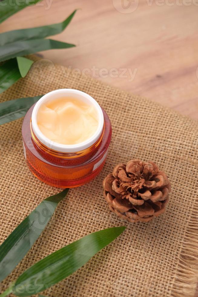 herbal cream cosmetic in a container on table, photo