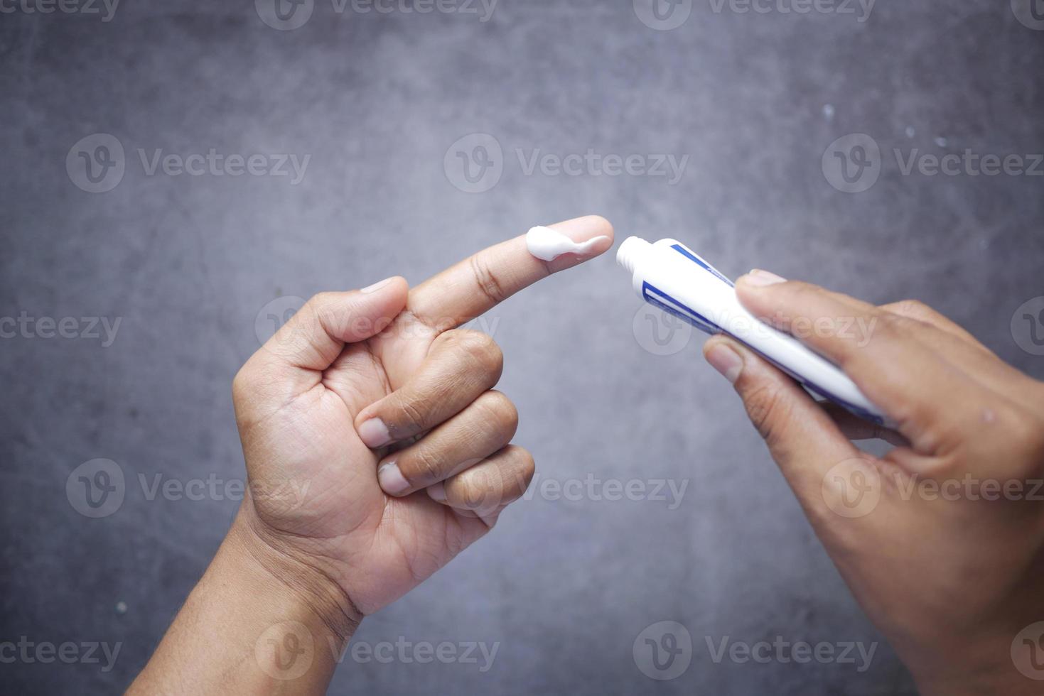 Man applying antibiotic cream top view photo