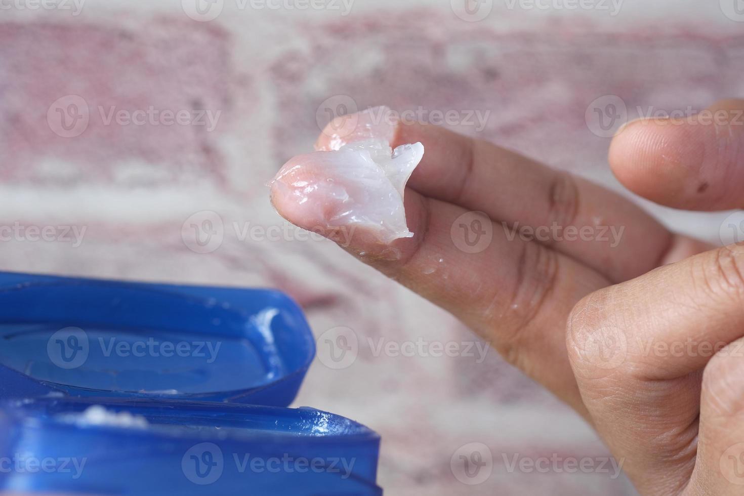 Close up of man hand using petroleum jelly photo