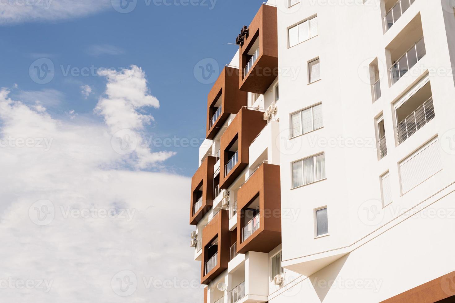Modern hotel or apartment building on sky background photo