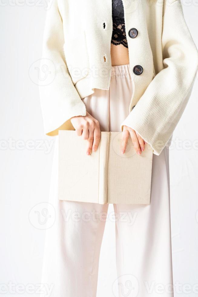 Beautiful sexy woman in comfortable home clothes reading a book photo