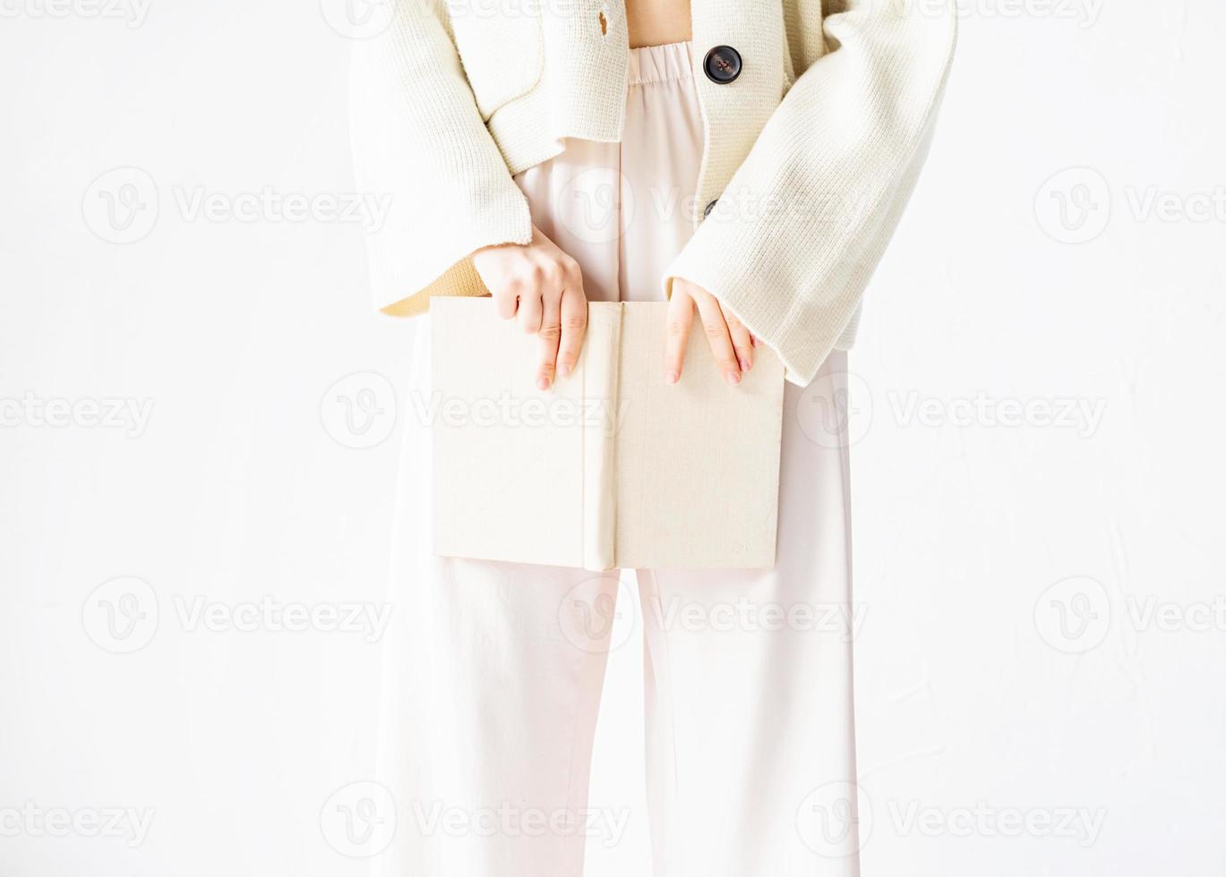 Beautiful sexy woman in comfortable home clothes reading a book photo