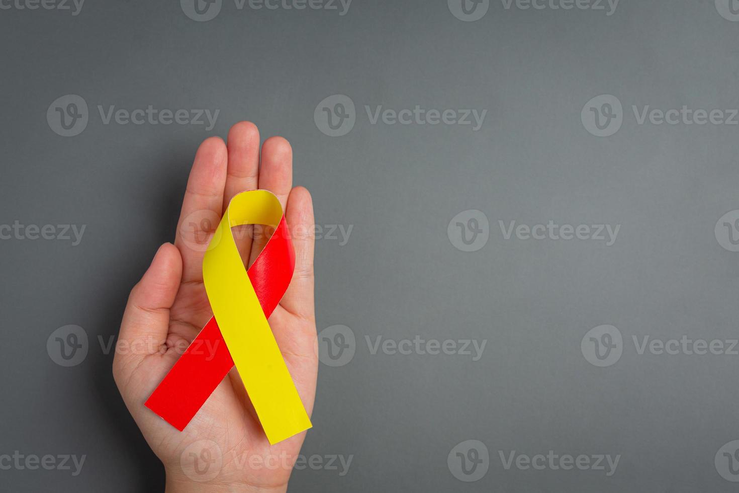 World hepatitis day awareness with red yellow ribbon photo