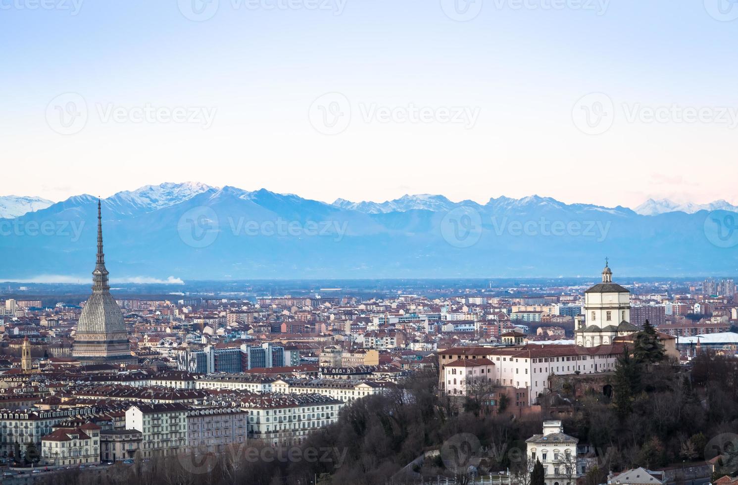 Horizonte panorámico de Turín al atardecer con los Alpes en segundo plano. foto