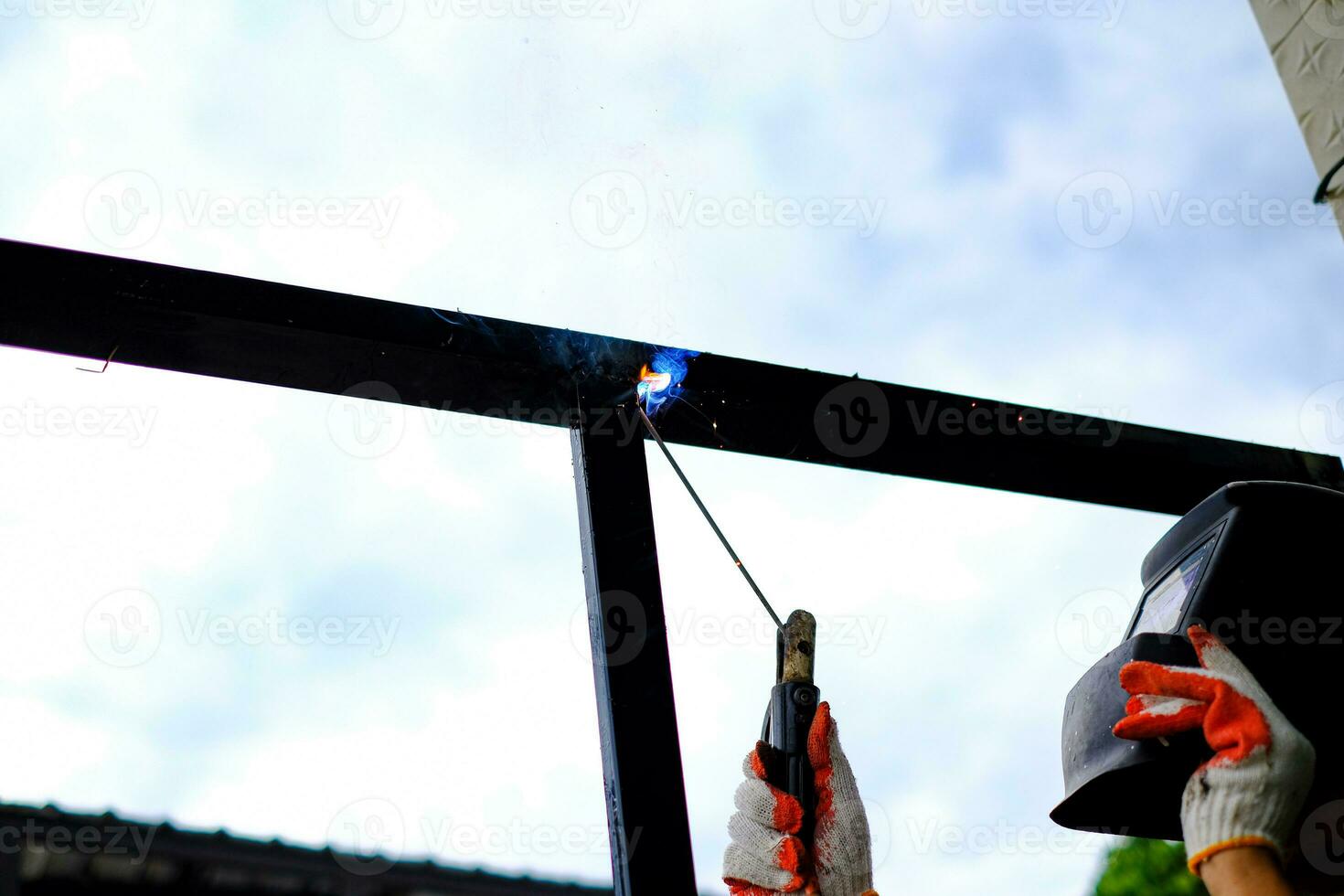 Welder Technician are welding steel with sparks photo