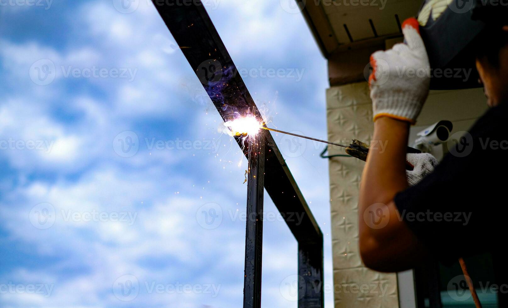 Welder Technician are welding steel with sparks photo