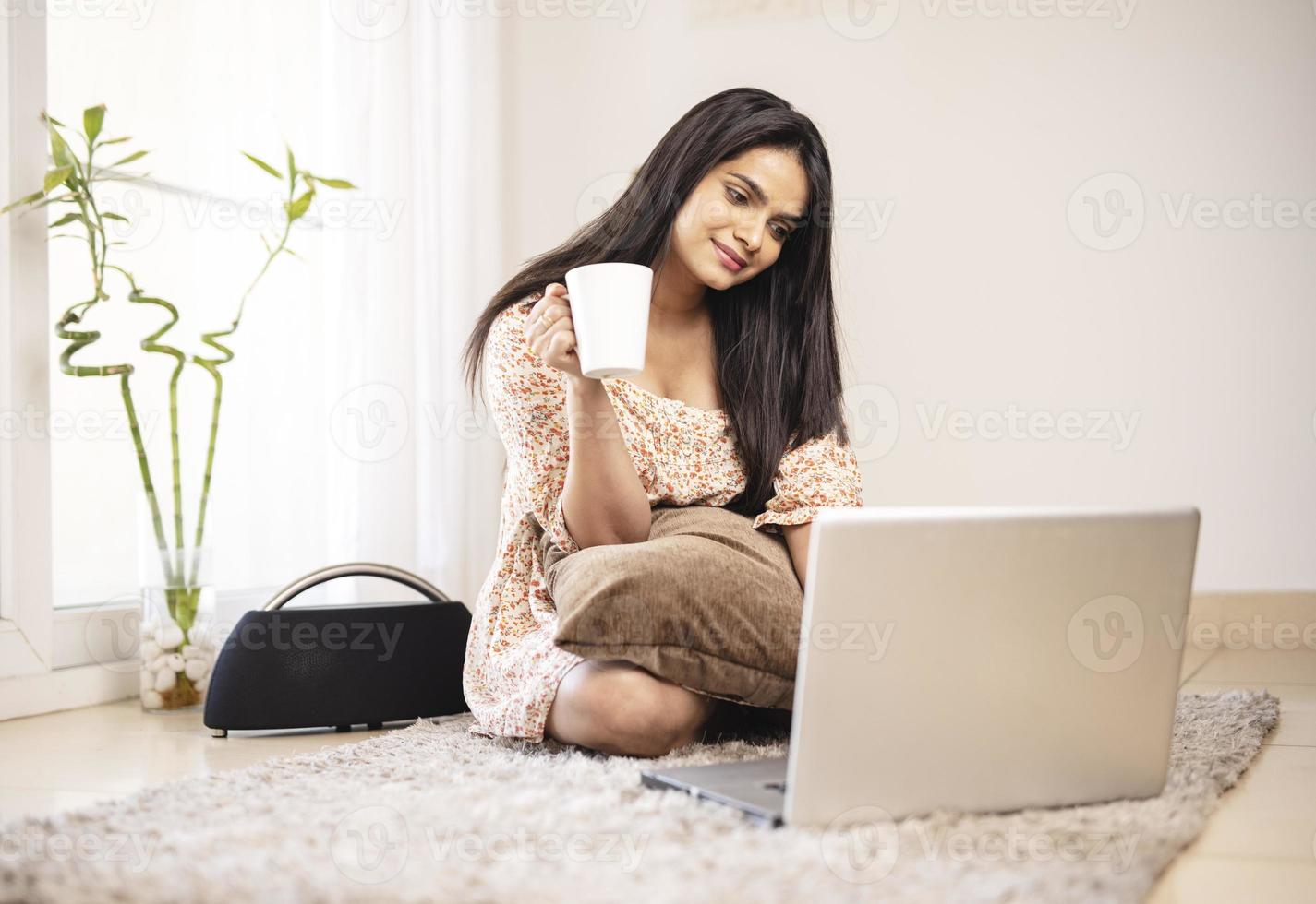Indian pretty young girl using laptop at home photo