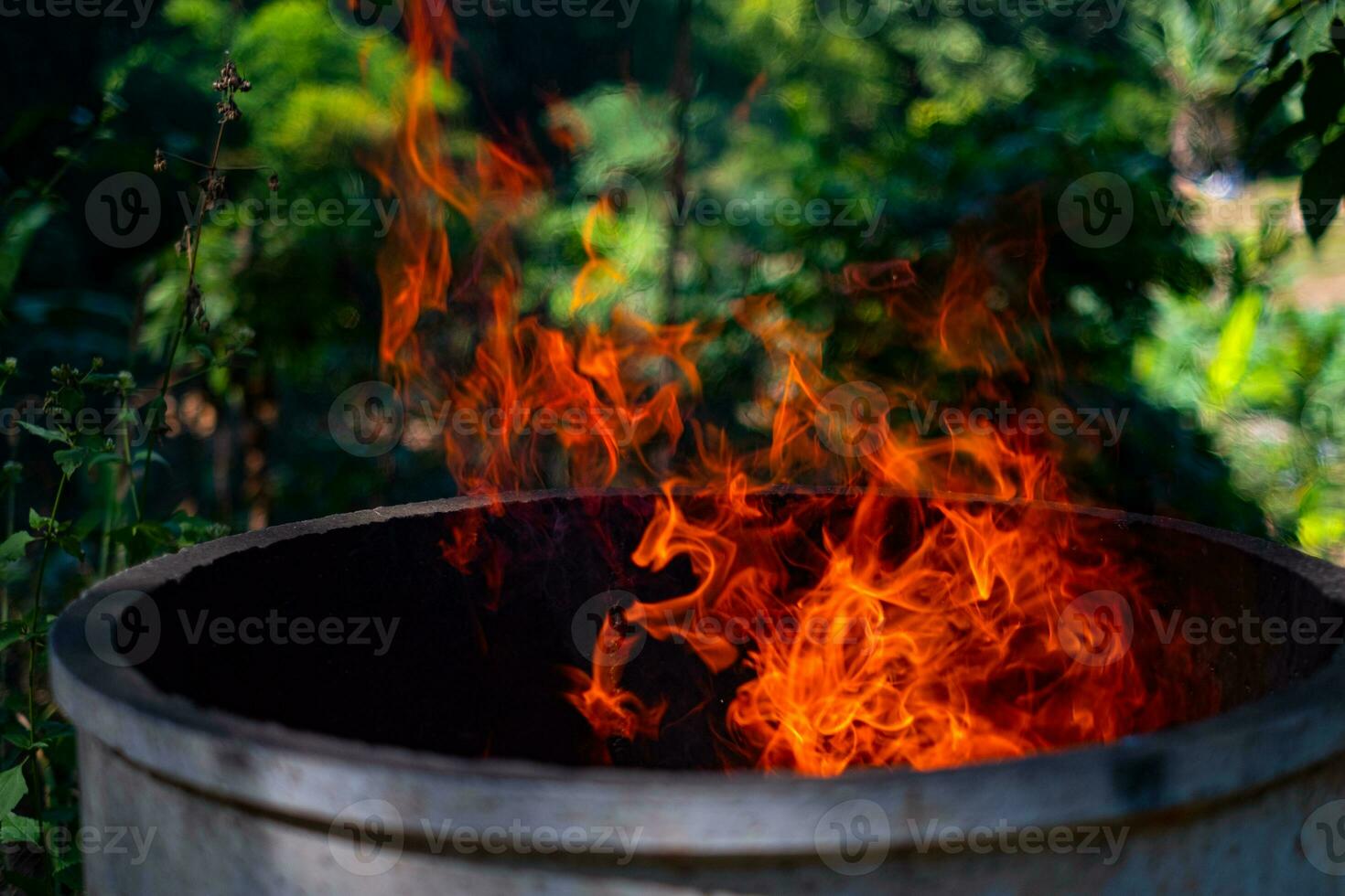 Cement tank at fire flames on blurred background photo