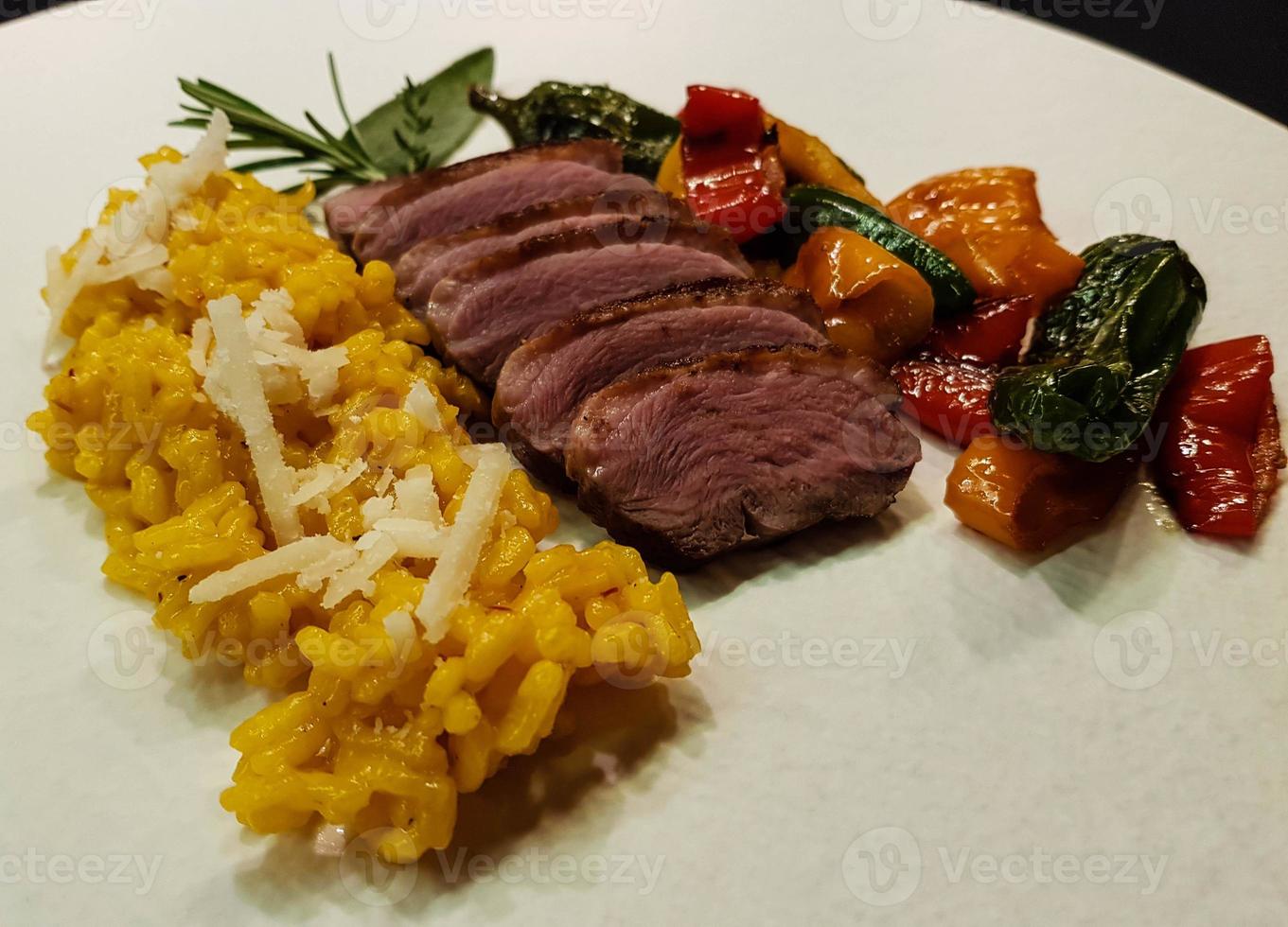 fried Duck breast with saffron risotto photo