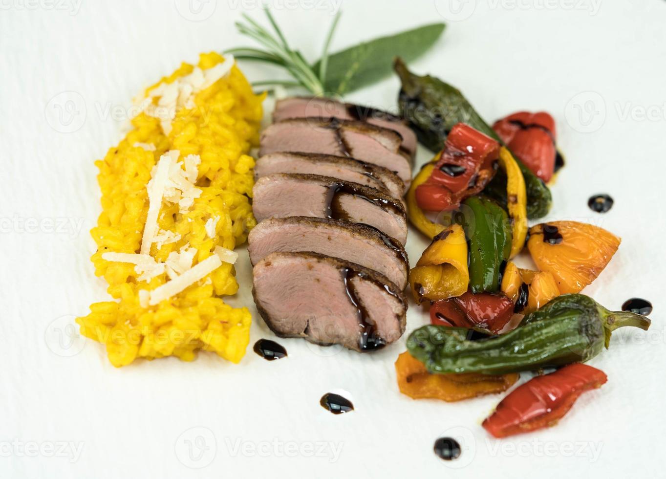 fried Duck breast with saffron risotto photo