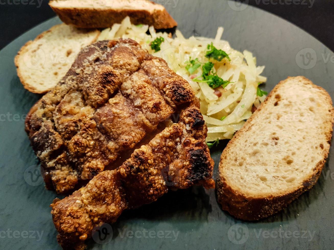 pork knuckle with sauerkraut and bread photo