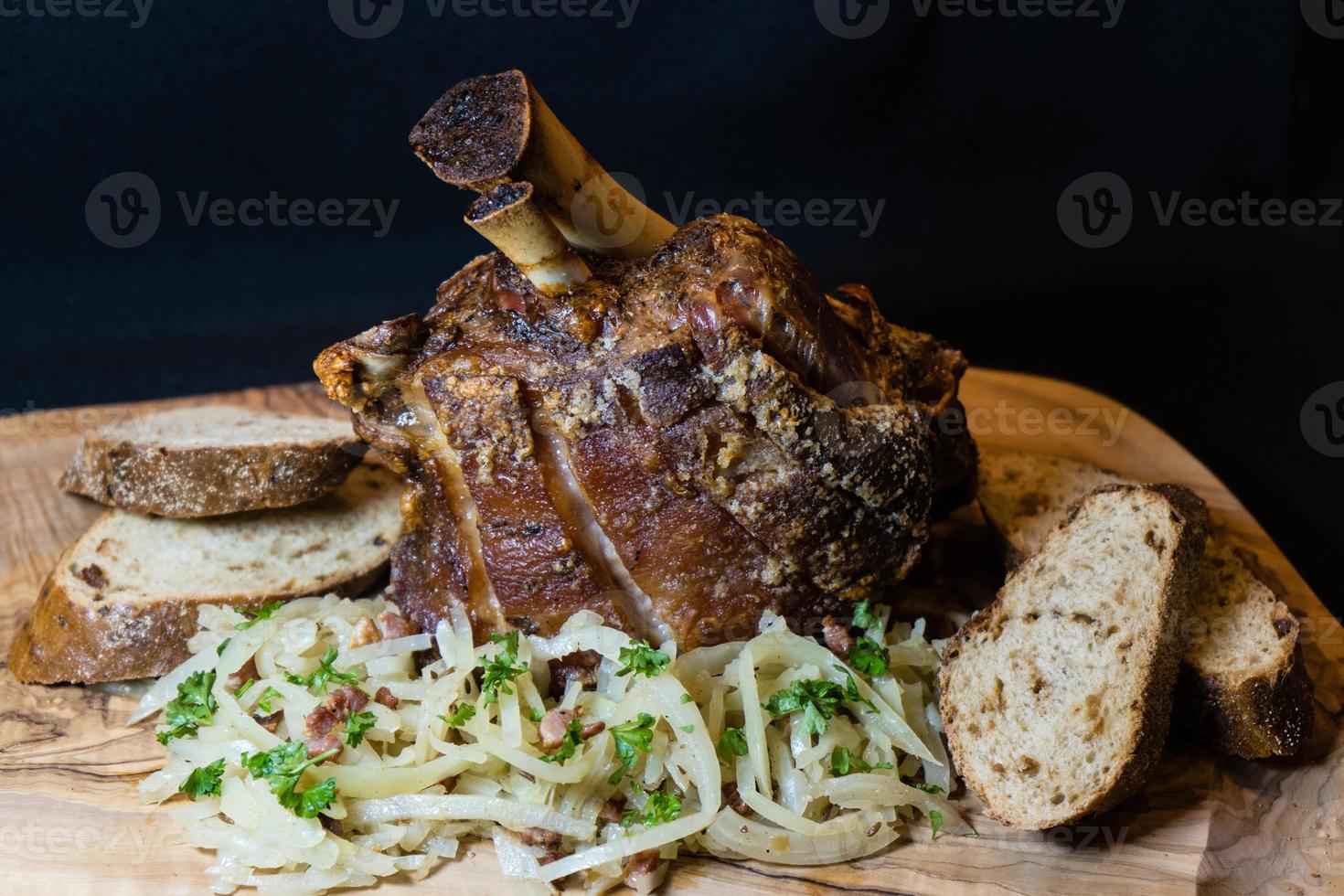 pork knuckle with sauerkraut and bread photo