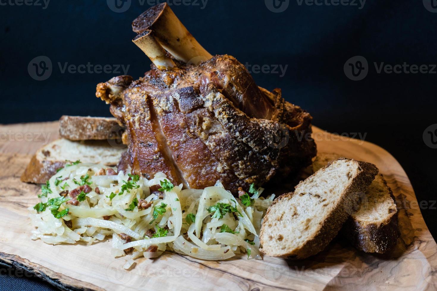pork knuckle with sauerkraut and bread photo