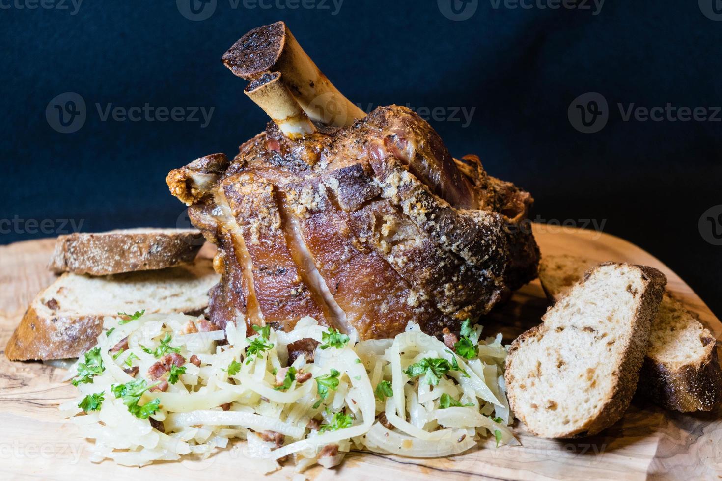 pork knuckle with sauerkraut and bread photo