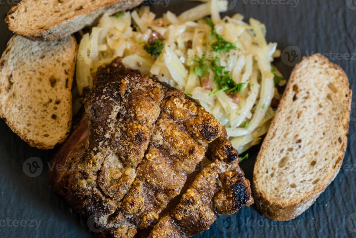 pork knuckle with sauerkraut and bread photo