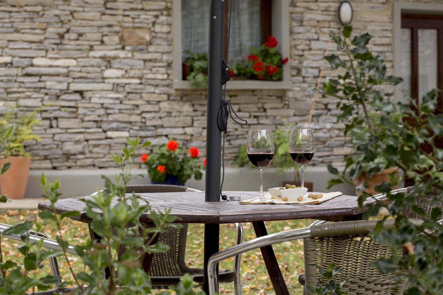 Two glasses of red wine in the courtyard of a house in Soria, Spain photo