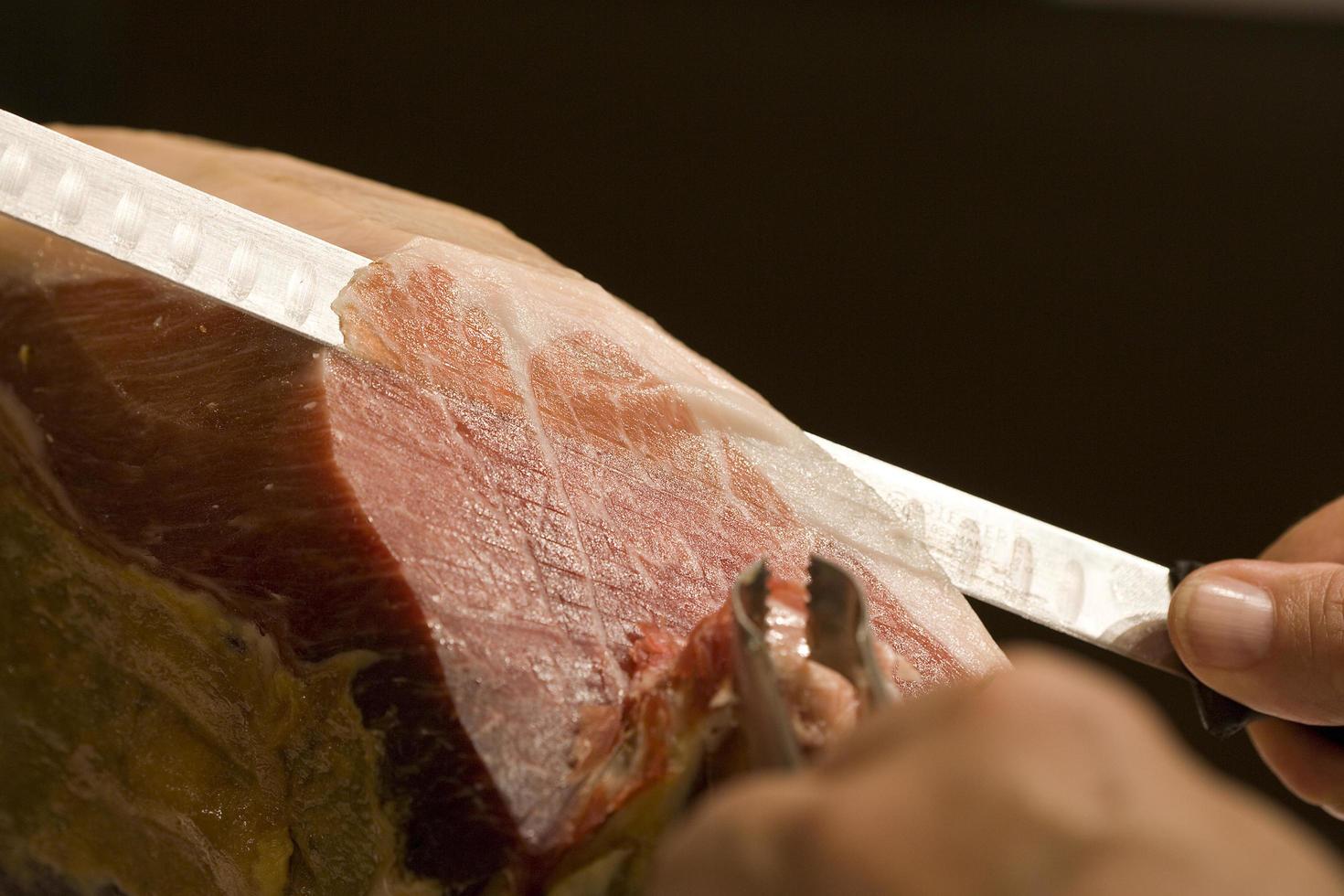 Serrano ham cut in Spain photo