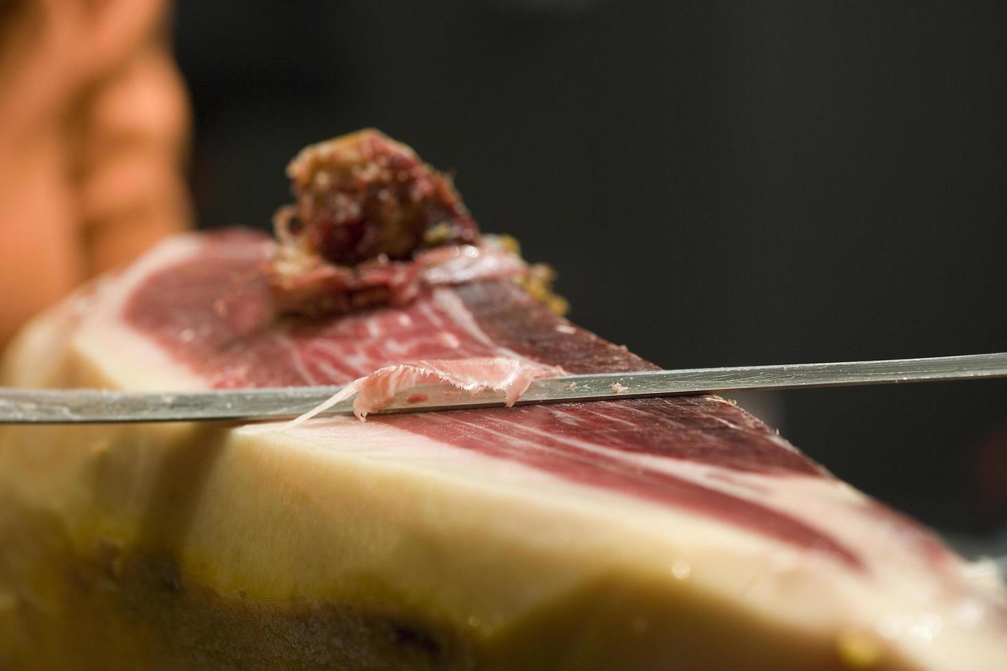 Serrano ham cut in Spain photo