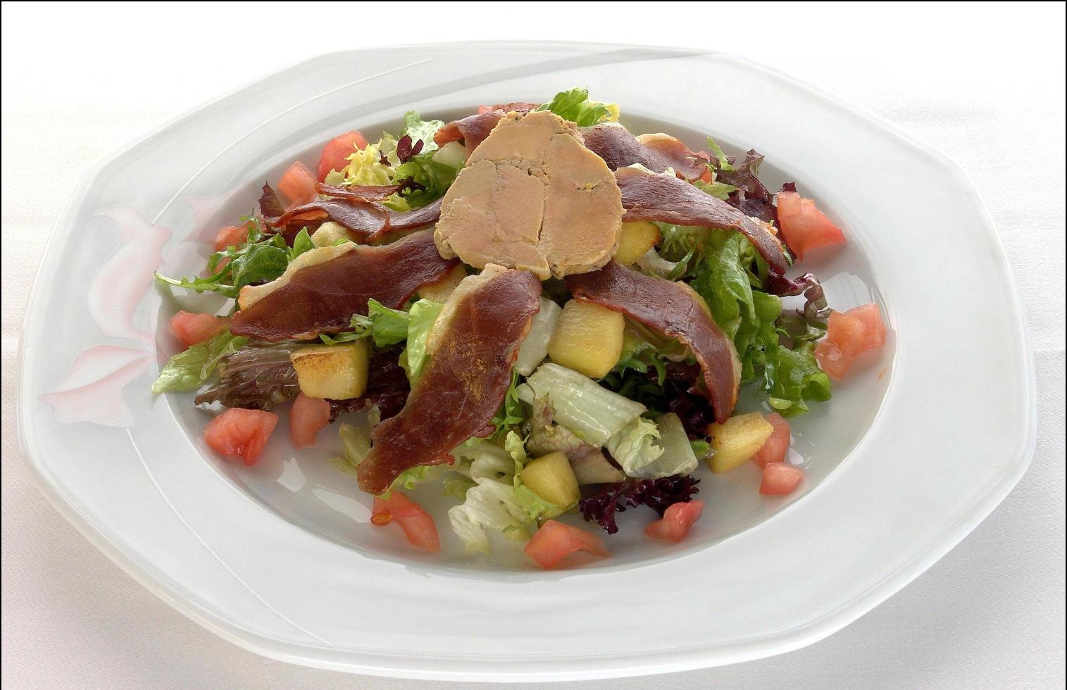 Salad with duck foie, tomatoes, lettuce and duck ham photo