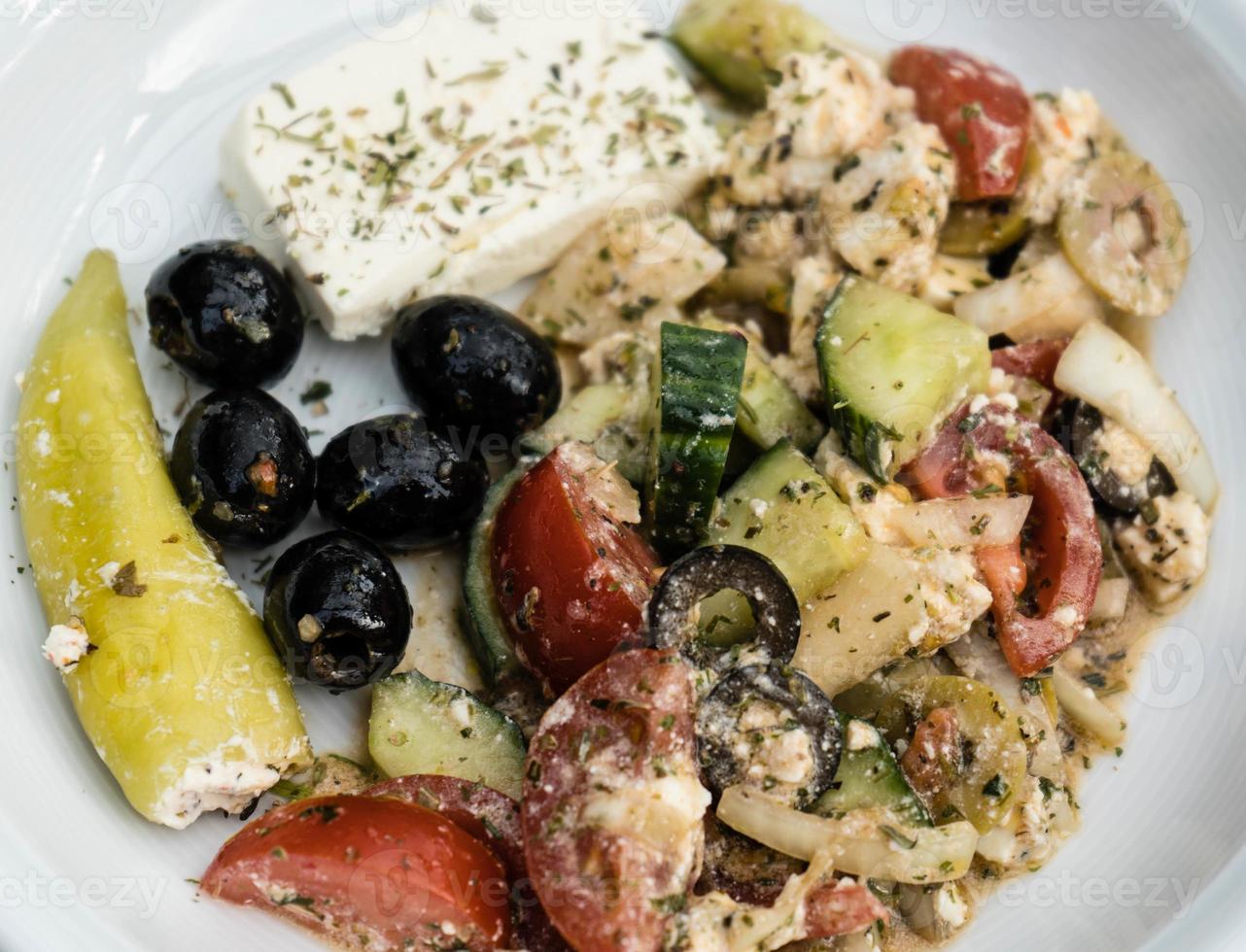 Greek salad with feta cheese olives and hot peppers photo