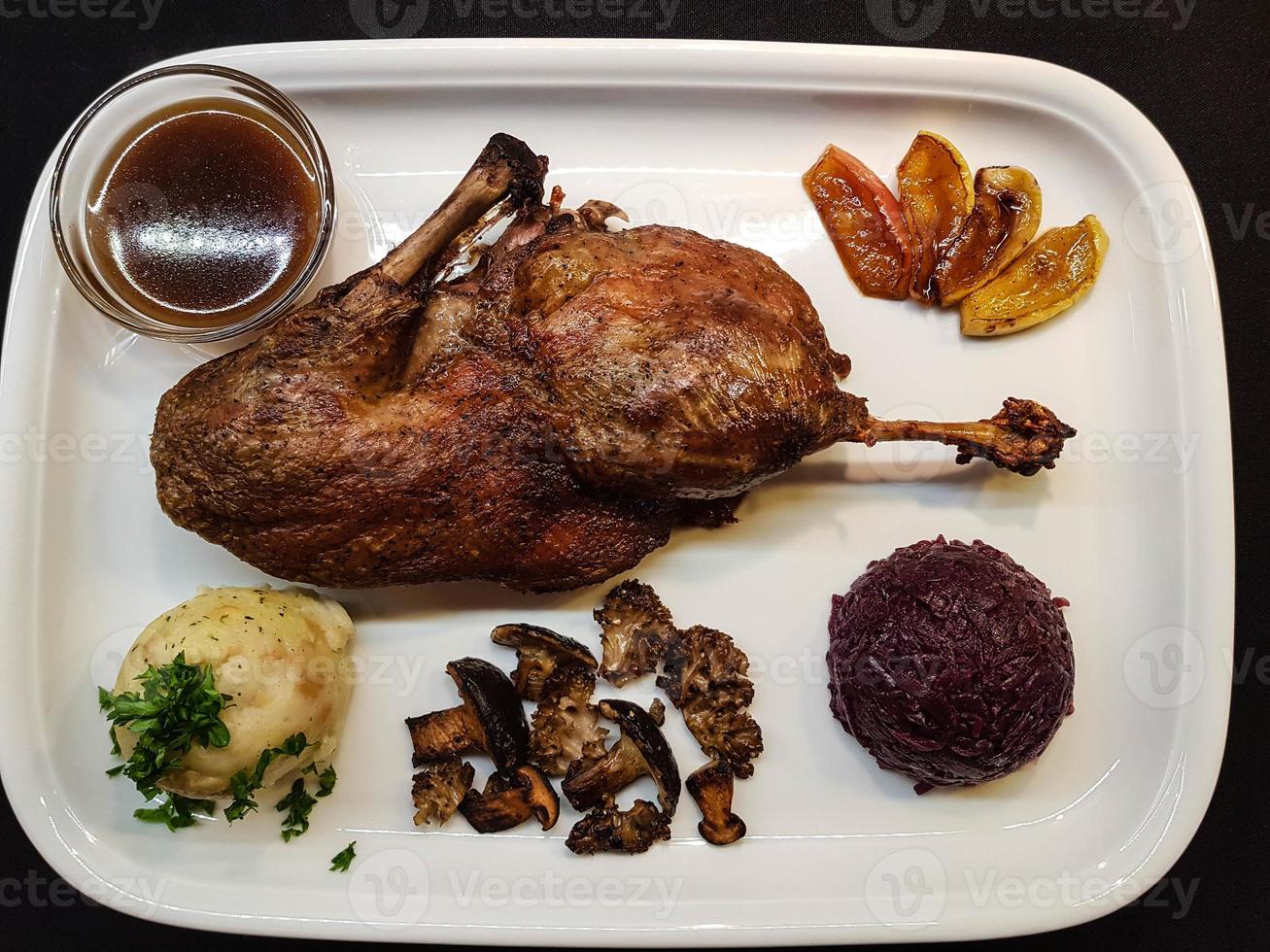 Baked Duck with red cabbage and forest mushrooms photo