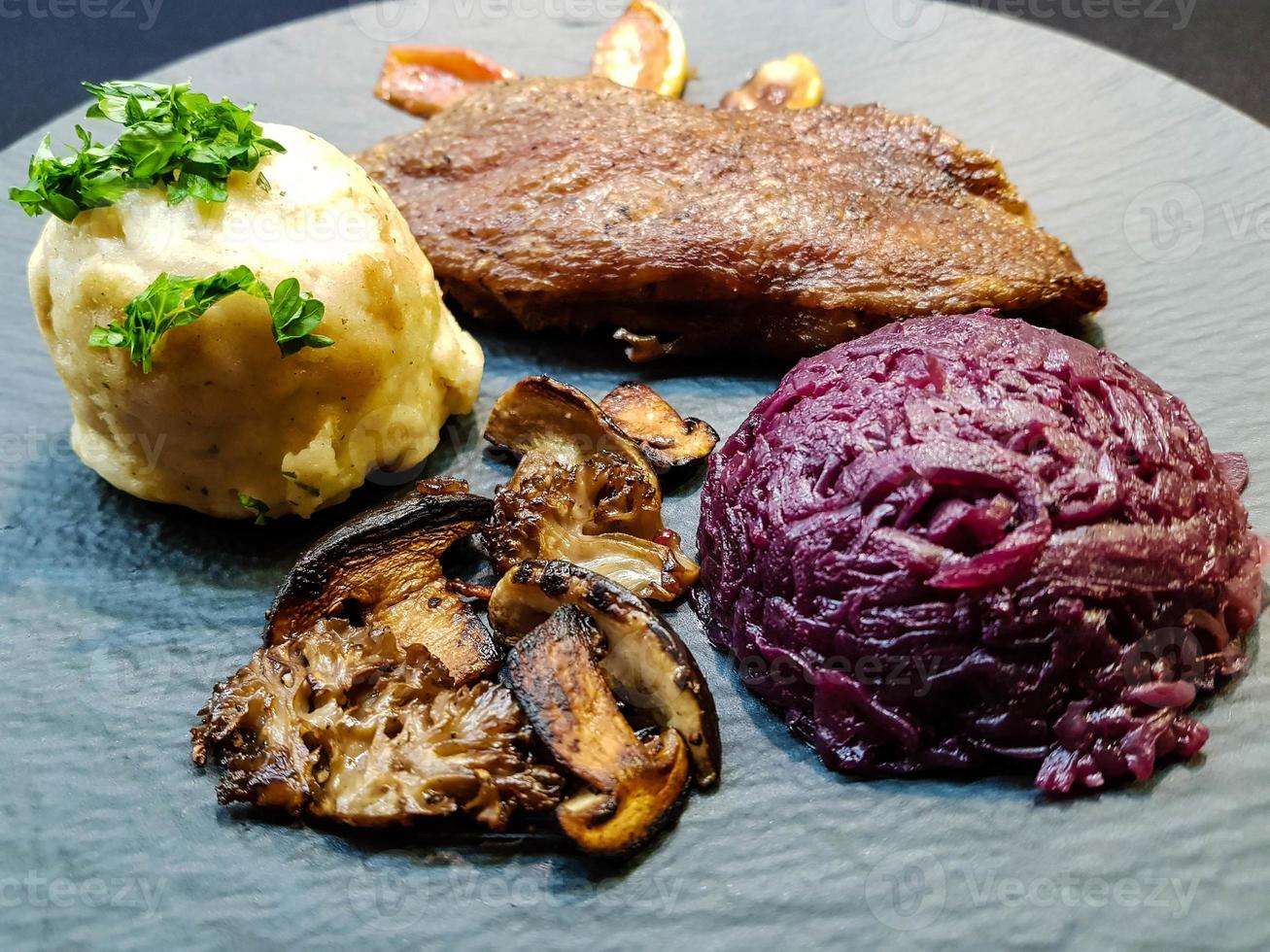 Baked Duck with red cabbage and forest mushrooms photo