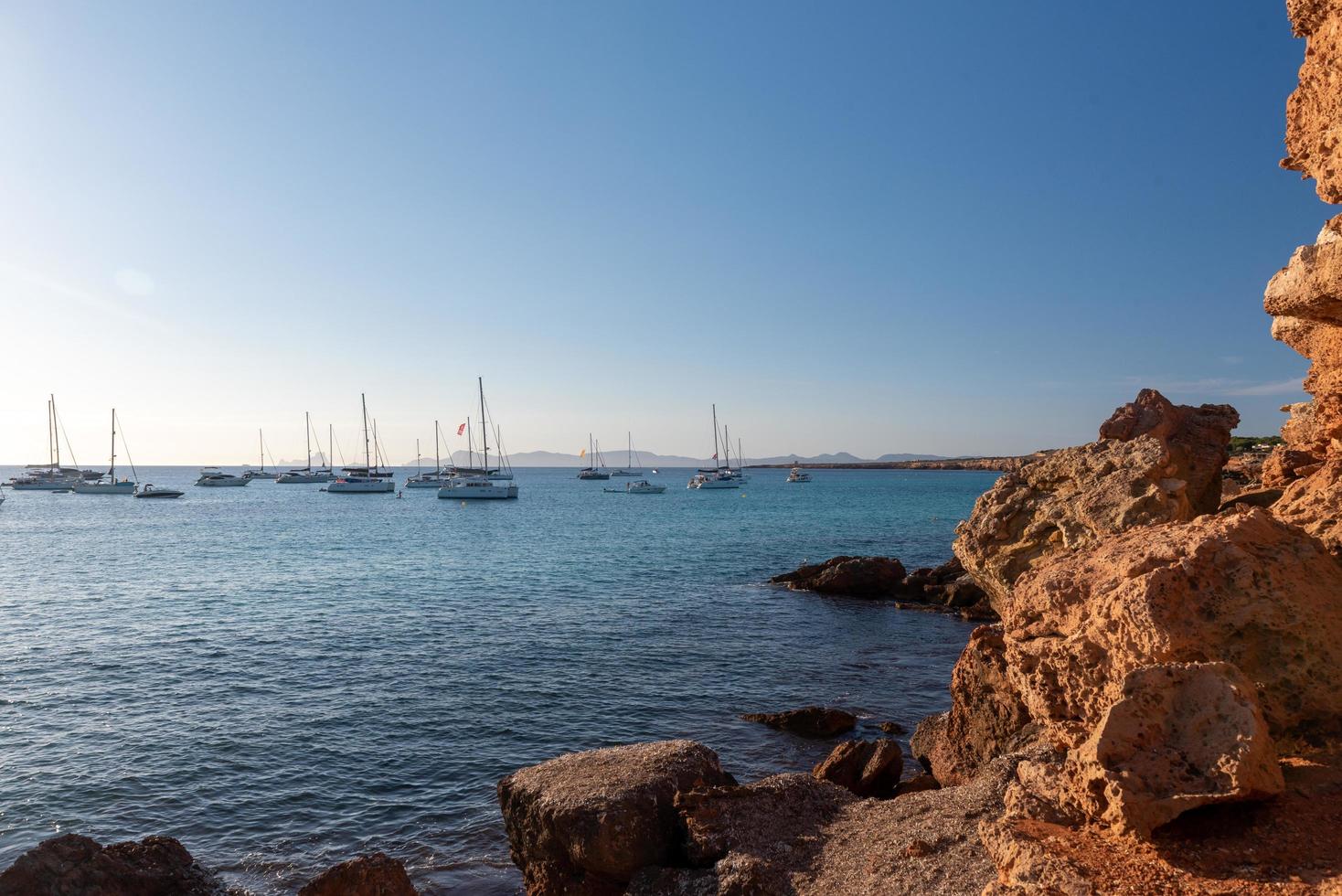 Boats in thebeach of Cala Saona photo