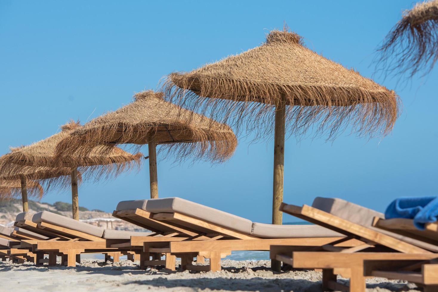 Deck chairs and straw umbrellas on the wonderful island of Formentera photo