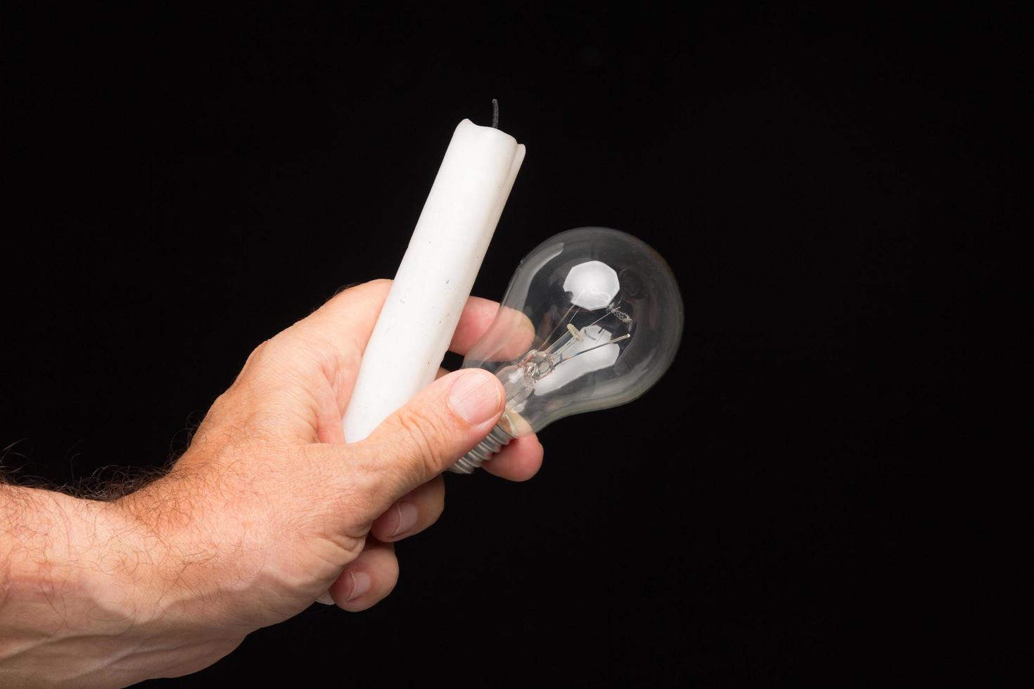 Light bulb in hand on a black background photo