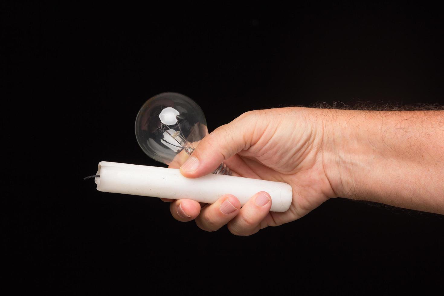 Light bulb in hand on a black background photo