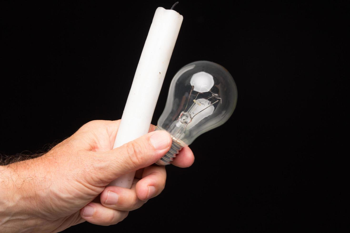 Light bulb in hand on a black background photo