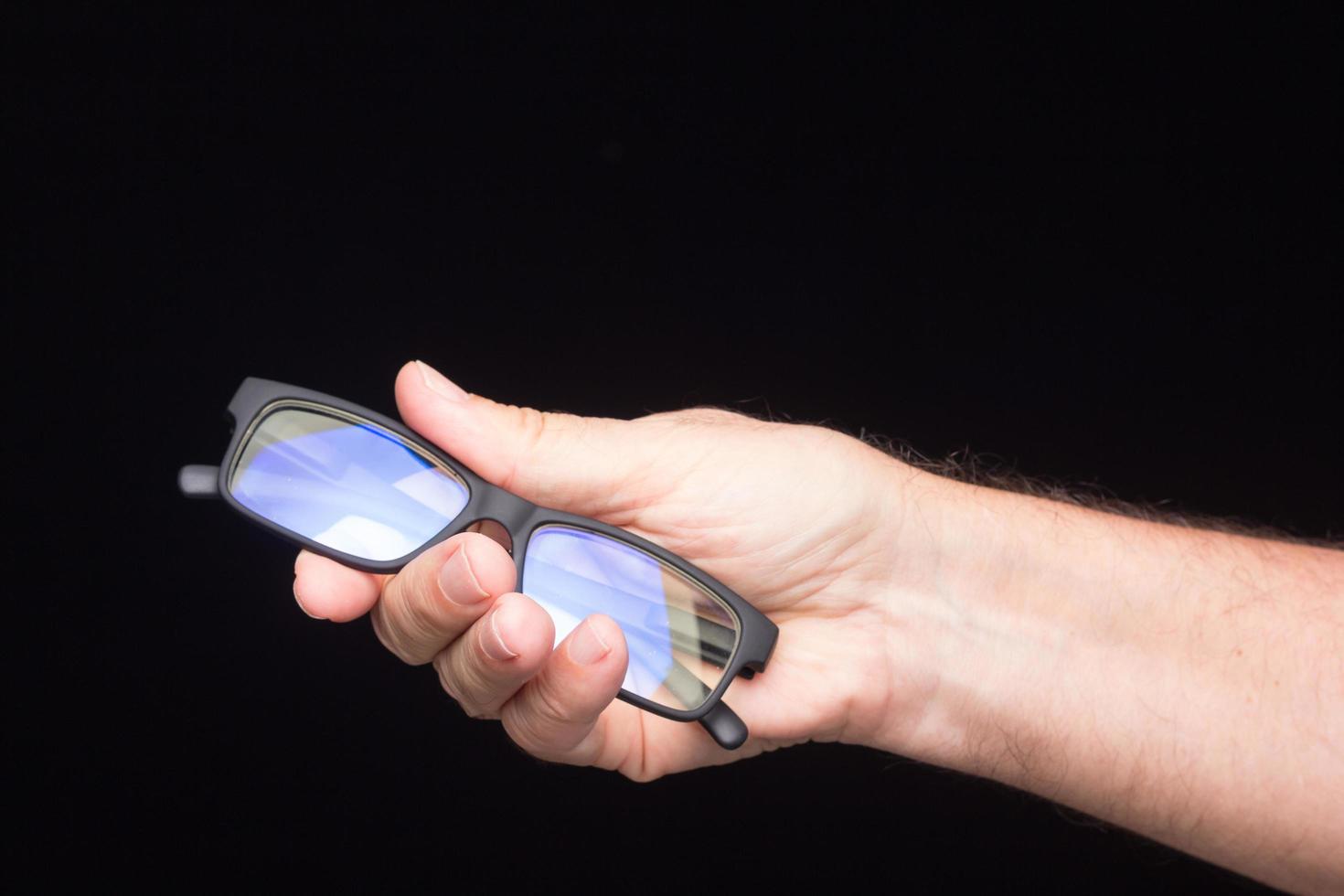 Glasses in the hand of a person photo