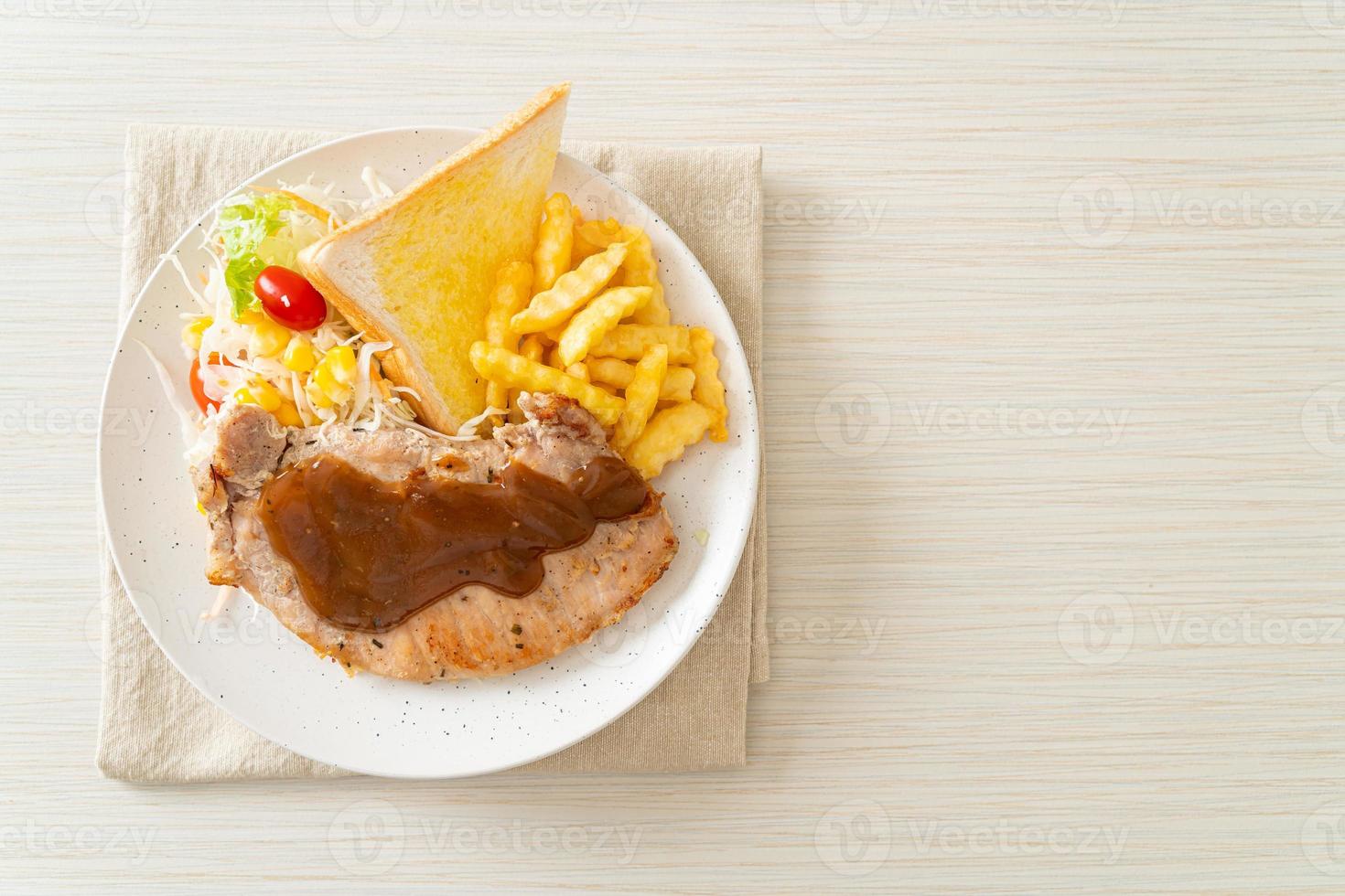 Pork steak with black peppers gravy sauce and mini salad photo